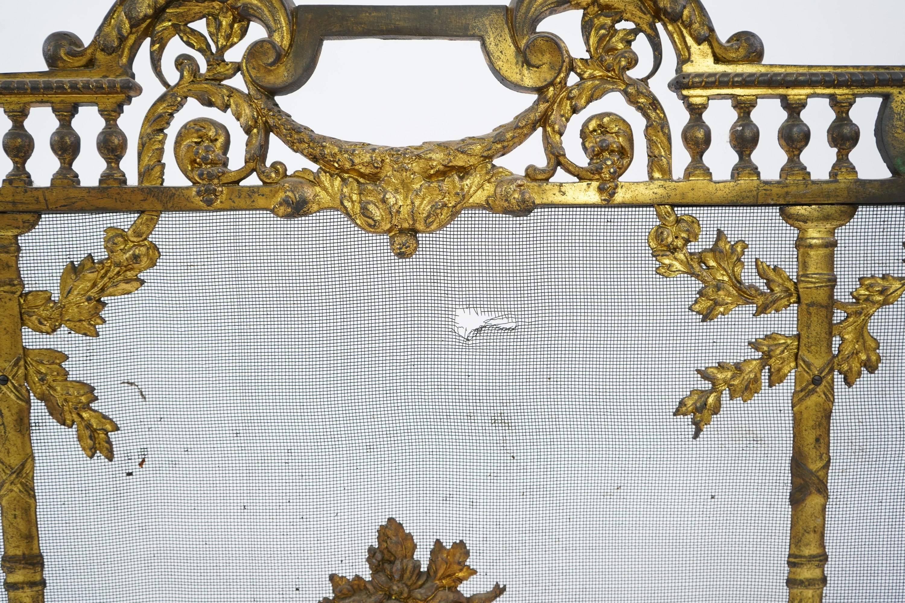 A Louis XVI style gilt bronze and iron mesh fireguard, late 19th century